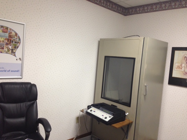audio testing booth in corner of office with equipment