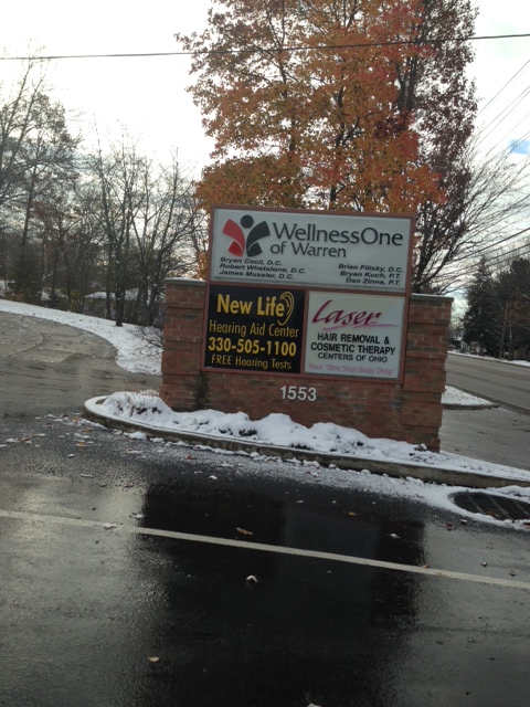 sign outside warren office displaying businesses at address
