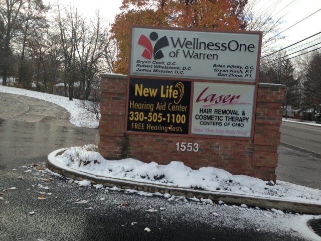 sign outside warren office displaying businesses at address